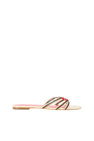 A single flat slide sandal shown in profile against a solid white background. The sandal features a light beige footbed, a red inner lining, and metallic gold-toned straps with a small red accent at the center.