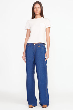 Full body shot of model in the loose jean in dark rinse.