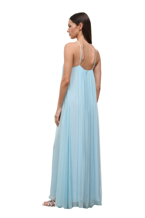 A woman modeling a light blue sleeveless maxi dress from the back, showing the open back and thin straps, against a plain white background.