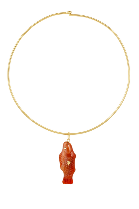 A gold wire necklace with a carnelian agate pendant shaped like a 'Swedish Fish' with two gold hearts on the back.
