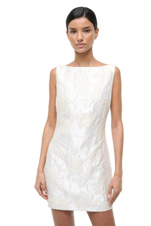 Woman wearing a white sleeveless dress on a white background