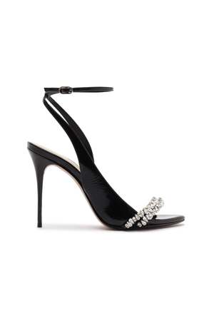 Black high-heeled shoe with embellishments on a white background