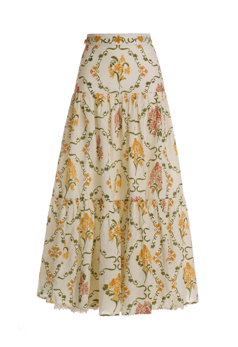 Flat lay of yellow floral maxi skirt on a white background