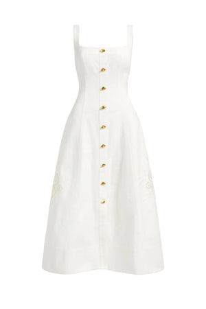 White maxi dress with gold buttons on a white background