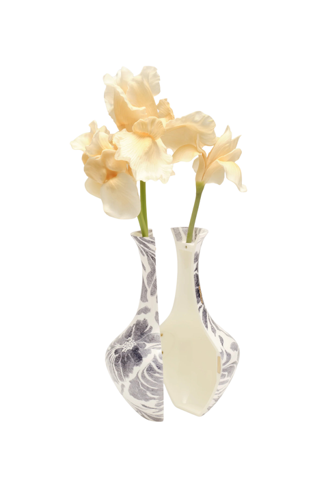 Two decorative ceramic bud vases with pale cream and gray marbled patterns, each holding a pale peach flower, isolated on a white background.