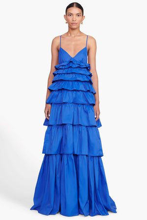 Model facing the camera in the bright blue tiered ruffle maxi dress