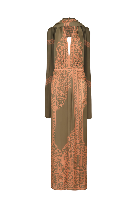 A long-sleeved maxi dress in olive green with a prominent terracotta orange paisley and geometric pattern, shown against a plain white background.