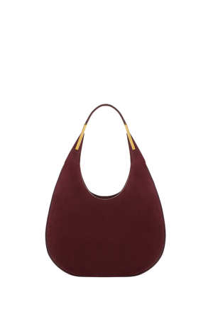 Maroon suede handbag with gold accents on a white background