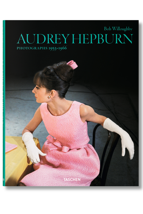 The front cover of the book 'Audrey Hepburn: Photographs 1953-1966' by Bob Willoughby, published by Taschen. The cover features a classic black-and-white photograph of Audrey Hepburn wearing a pink textured dress and white gloves, seated on a chair against a dark background.
