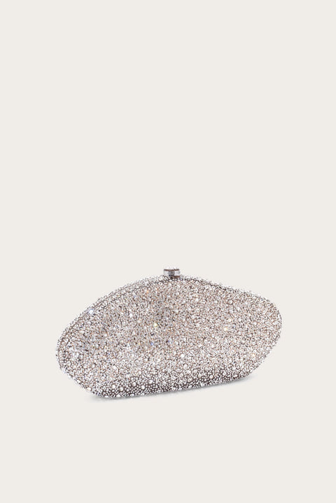 Silver glittery clutch bag on a light gray background placed at an angle.