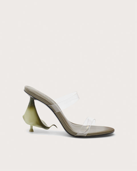Side profile of a green high heel with clear straps and a calla lily shaped heel.