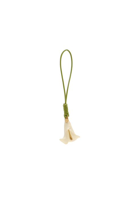 Small white calla lily bag charm on a green leather cord.