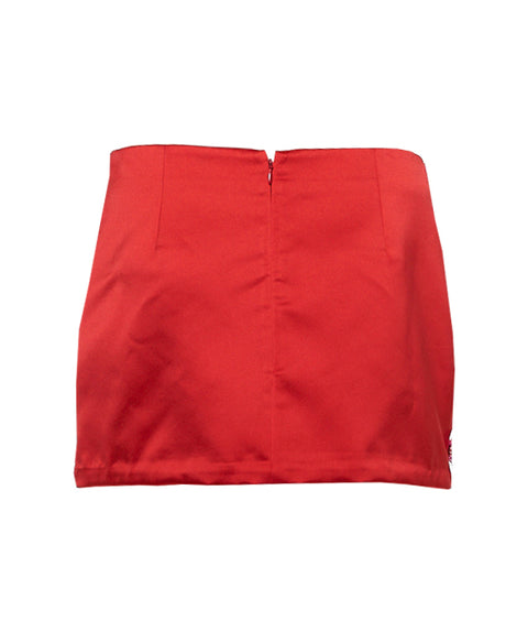 Back of red satin mini skirt on a white background