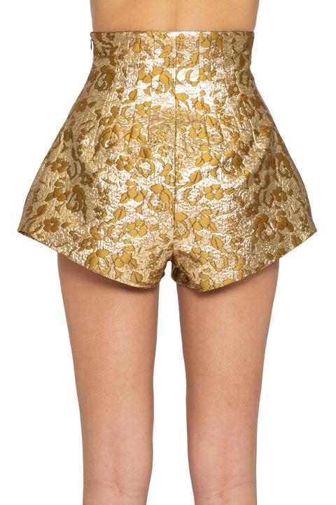 Gold floral shorts on a plain background
