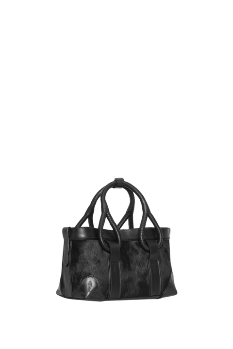 A black leather tote bag with textured panels and two top handles, photographed against a plain white background.