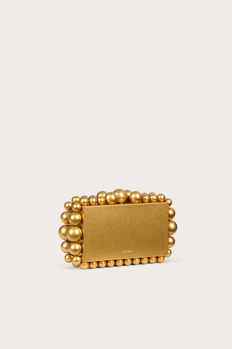 Side angle of a gold-toned metal rectangular clutch that features matching beads in graduating size lining the perimeter.