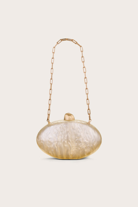 Oval-shaped clutch made out of pearlized acrylic, featuring gold hard wear and a detachable gold chain.