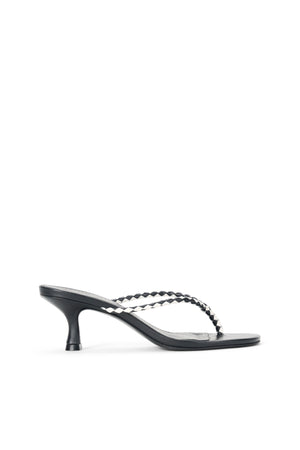 Side profile of a black thong kitten heel sandal that features black and white checkered straps.