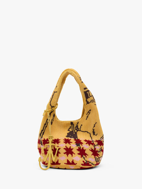 Yellow beaded handbag with a pattern on a white background