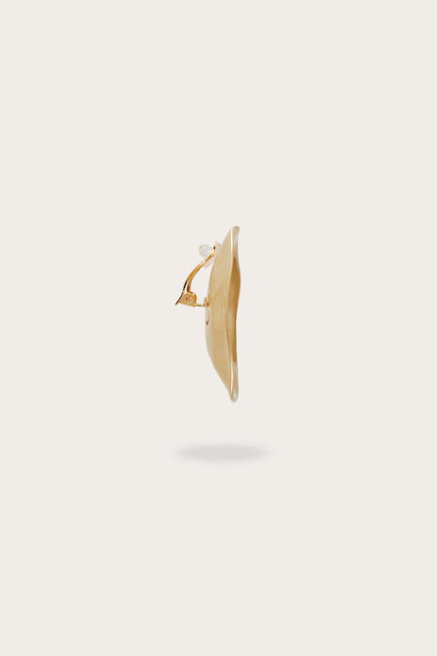 Gold oversized earring from the side.