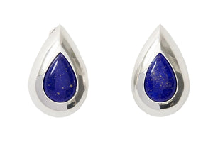 A pair of silver teardrop-shaped earrings with deep blue lapis lazuli stones in the center, set against a plain white background.