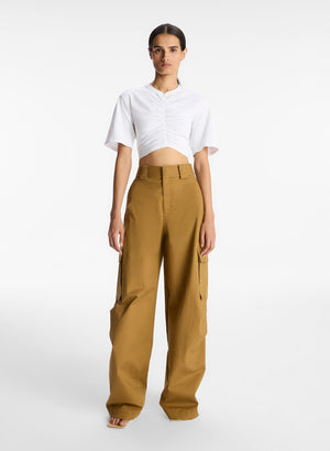 Model facing the camera in the cropped ruched short sleeve tee