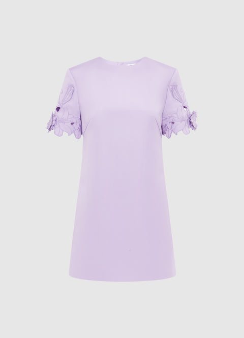 Lavender mini dress with floral applique details the sleeves on a white background