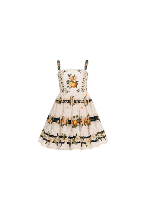 Flat lay of cream mini dress with orange fruit print and square neck on white background