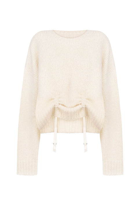 Flat lay of white knit sweater with low hanging ties