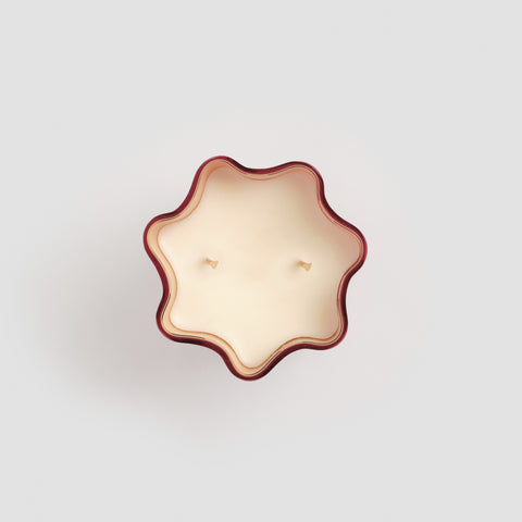 Bird's eye view of the top of the scalloped murano glass candle.'