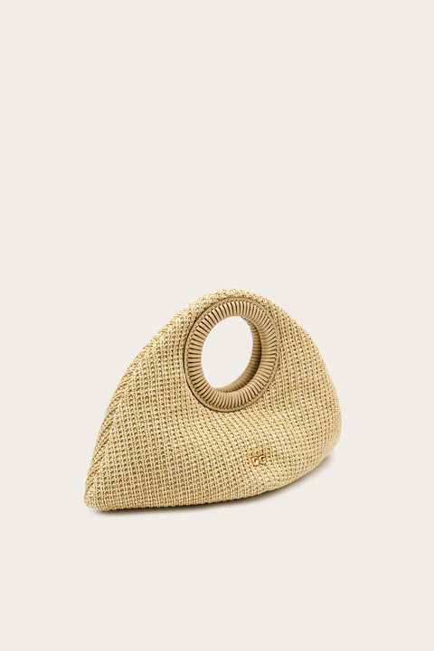 Side angle of a beige woven handbag with circular handles on a beige background