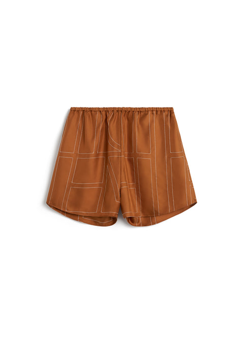 Orange silk shorts with elastic waist and white contrast logo stitching throughout.