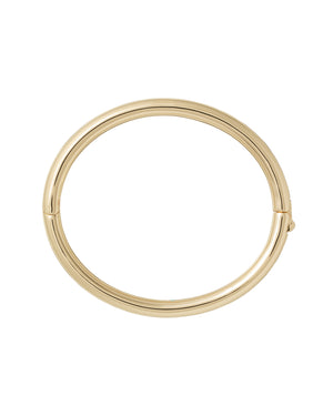 A gold-toned, tubular bangle with a hinge clasp.