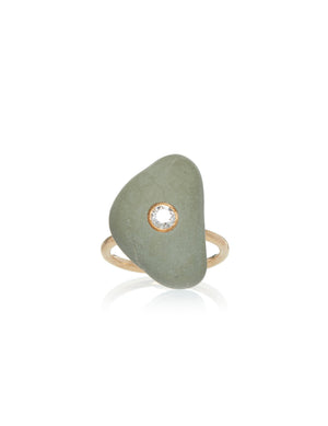 A light green triangular stone embellished with a round diamond in the center, set on a yellow gold ring band.