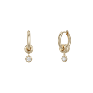 Ghost image of 18k yellow gold mini hoop earring that features three 18k yellow gold annulets, one with a round white diamond charm.