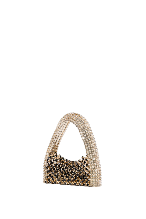 A small structured handbag covered in rhinestones, featuring a curved top handle and a body with clear rhinestones transitioning into black rhinestones, set against a plain white background.