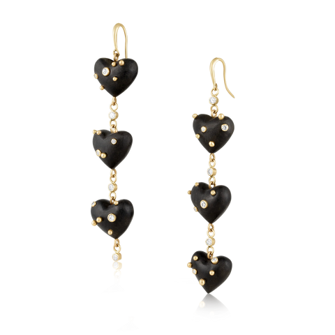 Pair of black heart-shaped earrings with gold accents on a white background