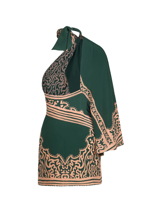 A green and salmon patterned one-sleeve mini dress with a halter tie-neck and open back
