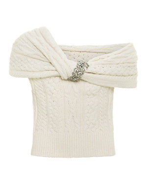 White cable knit top with a decorative crystal embellishment on a white background