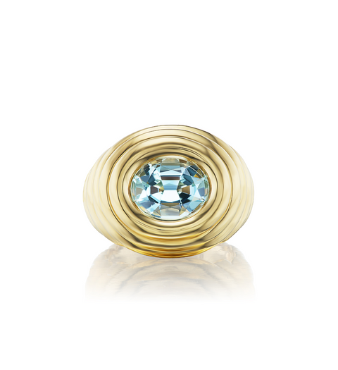 Gold ring with a blue gemstone on a white background