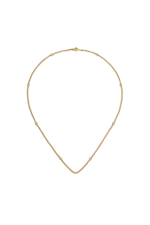 Gold necklace on a light beige background