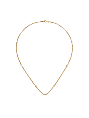 Gold necklace on a light beige background