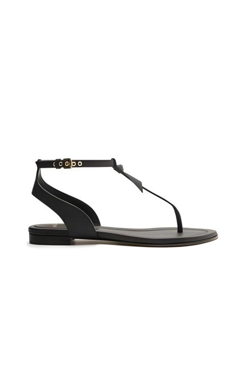 Black flat sandal with thin strap on a white background