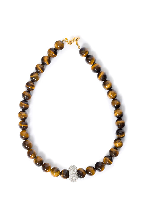 Necklace with tiger eye beads and strass charm with a gold clasp on a white background
