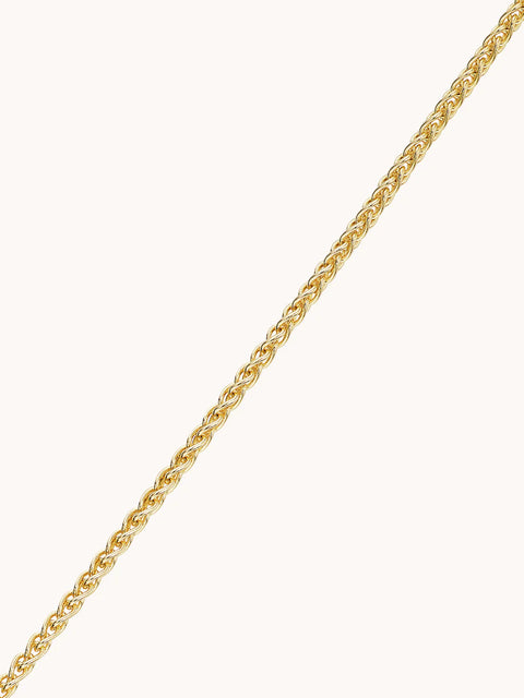 Close up of a yellow gold 1.8mm wheat chain necklace.