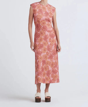 Model shot from the neck down wearing the pamela sleevless dress in pink floral multi.