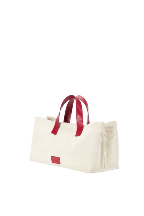 Beige tote bag with red handles and accents on a white background