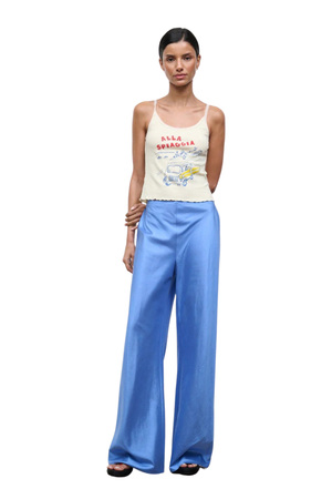 A woman wearing bright blue silk trousers