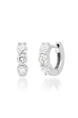 Pair of silver diamond hoop earrings with clear gemstones on a white background