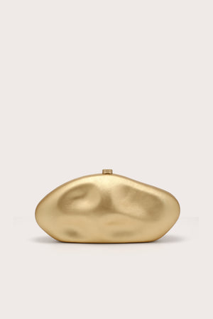 A gold, oval-shaped sculptural clutch. 
